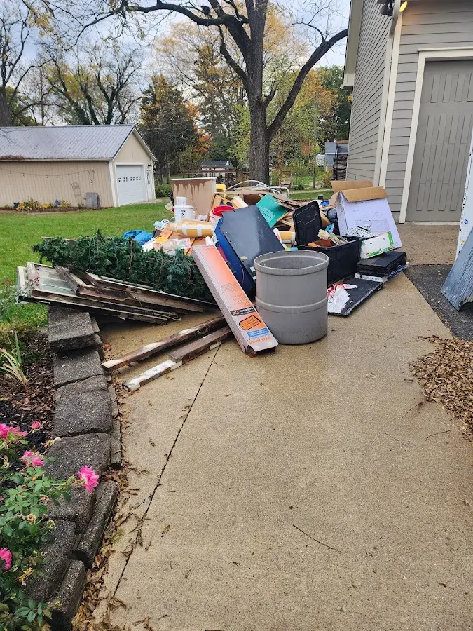 Dumpster being loaded with debris for Estate Cleanout Dumpster Rental in Lake in the Hills